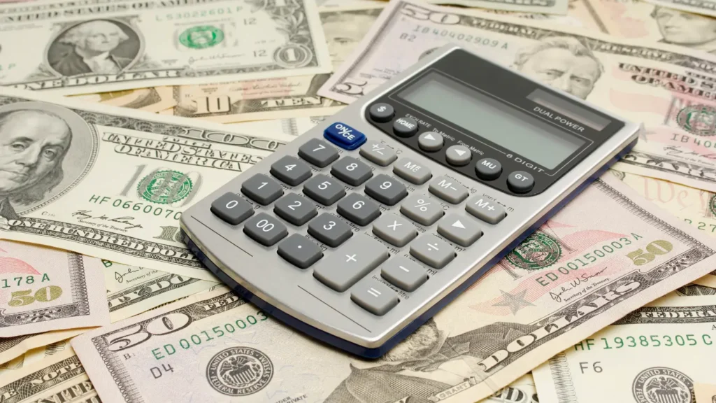 Calculator on US dollar bills. Calculate poker odds.