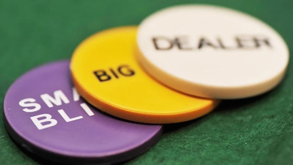 Poker chips labeled small blind, big blind and dealer.