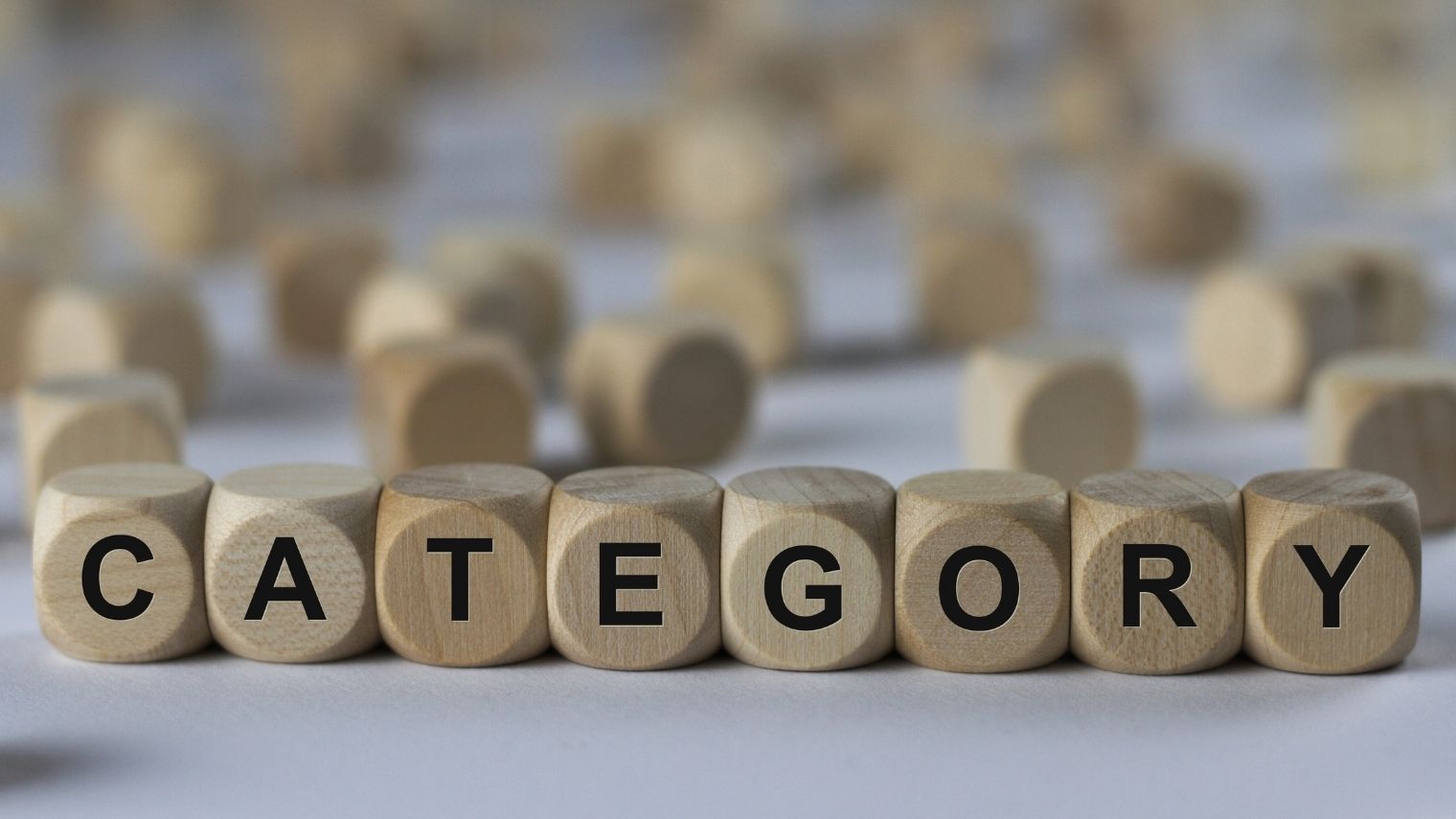 Wooden blocks spelling “CATEGORY”, illustrating preflop hand categories in poker.