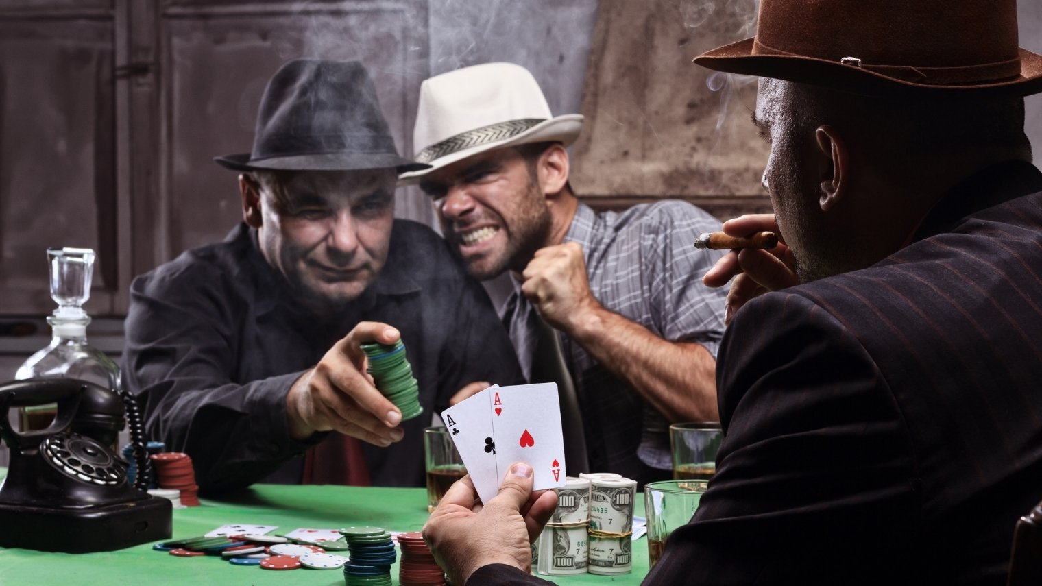 Poker player going all-in with pocket aces.