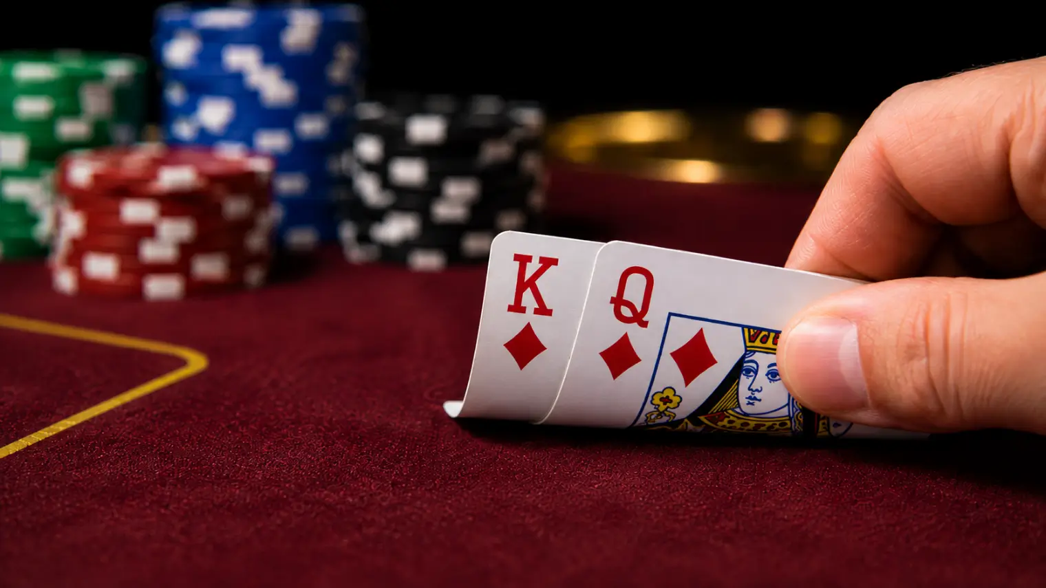 Poker player holding king-queen suited preflop with poker chips in the background.