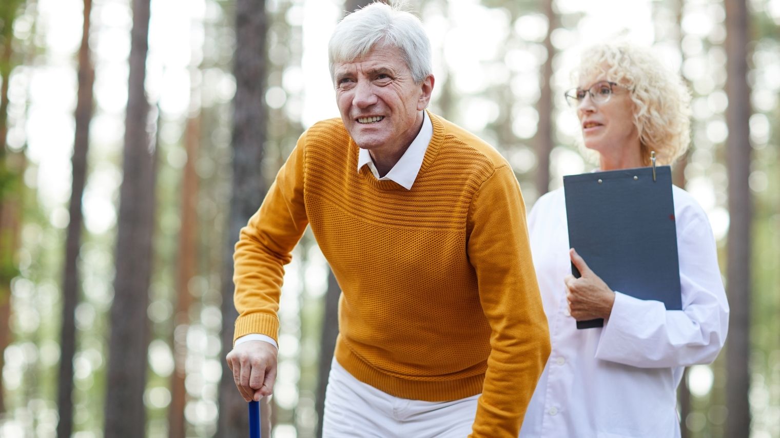 A man walking with a cane accompanied by a healthcare professional, illustrating the poker term “limping.”
